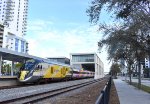 Brightline Bright Pink train at West Palm Beach Station heading southbound to Miami 